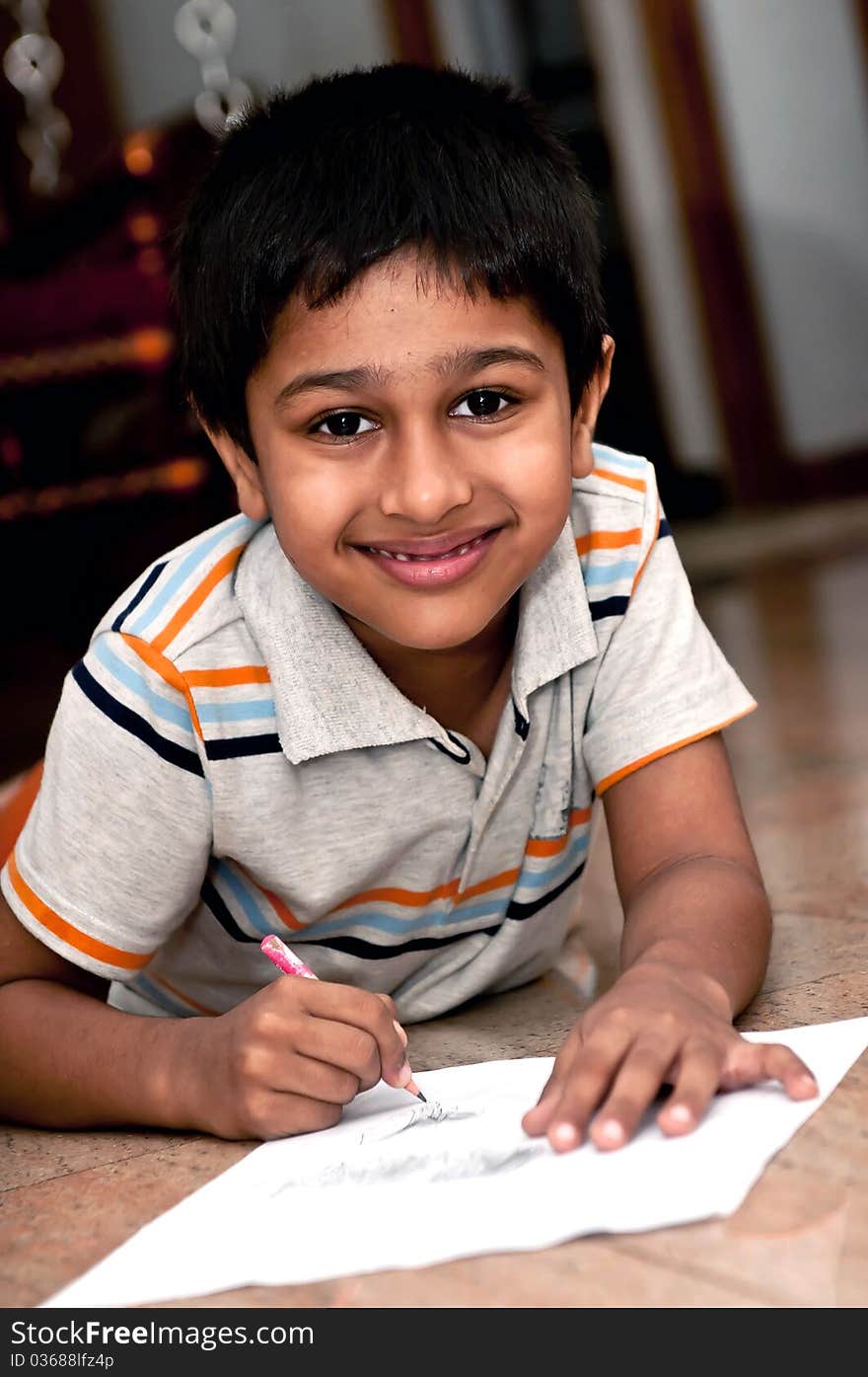 An handsome indian kid doing homework