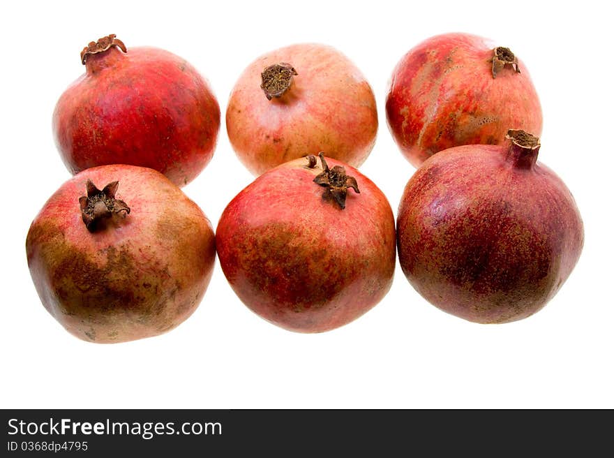 A little red pomegranates lying together on a white background