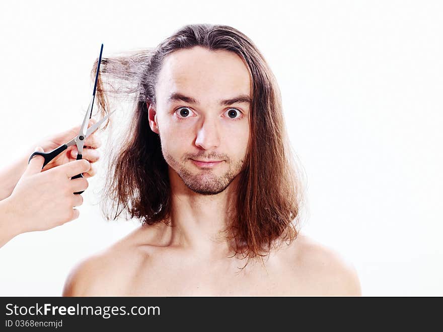 Young joyful man with long hair in barbershop. Young joyful man with long hair in barbershop