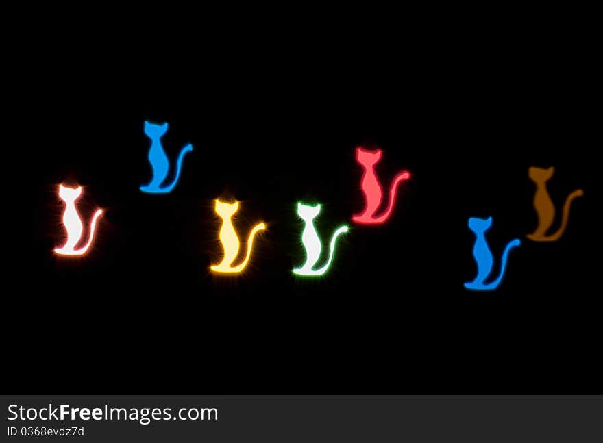 Light effect in the form of cats on black background. Light effect in the form of cats on black background