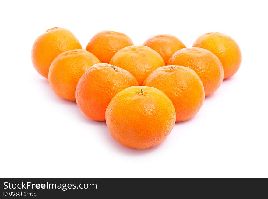 A pyramid of fresh tangerines isolated on white background