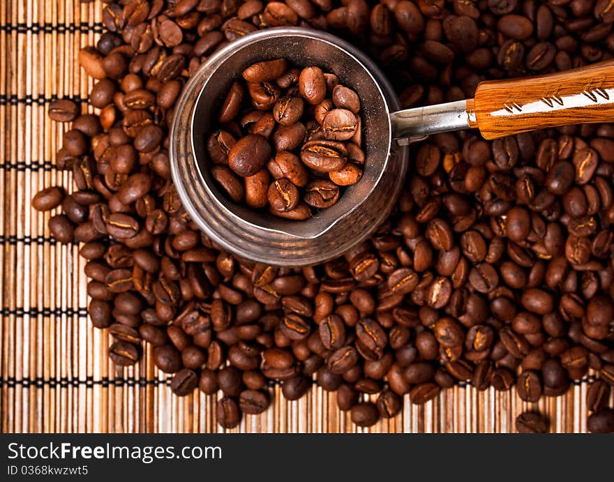 Roasted coffee beans and coffee pot