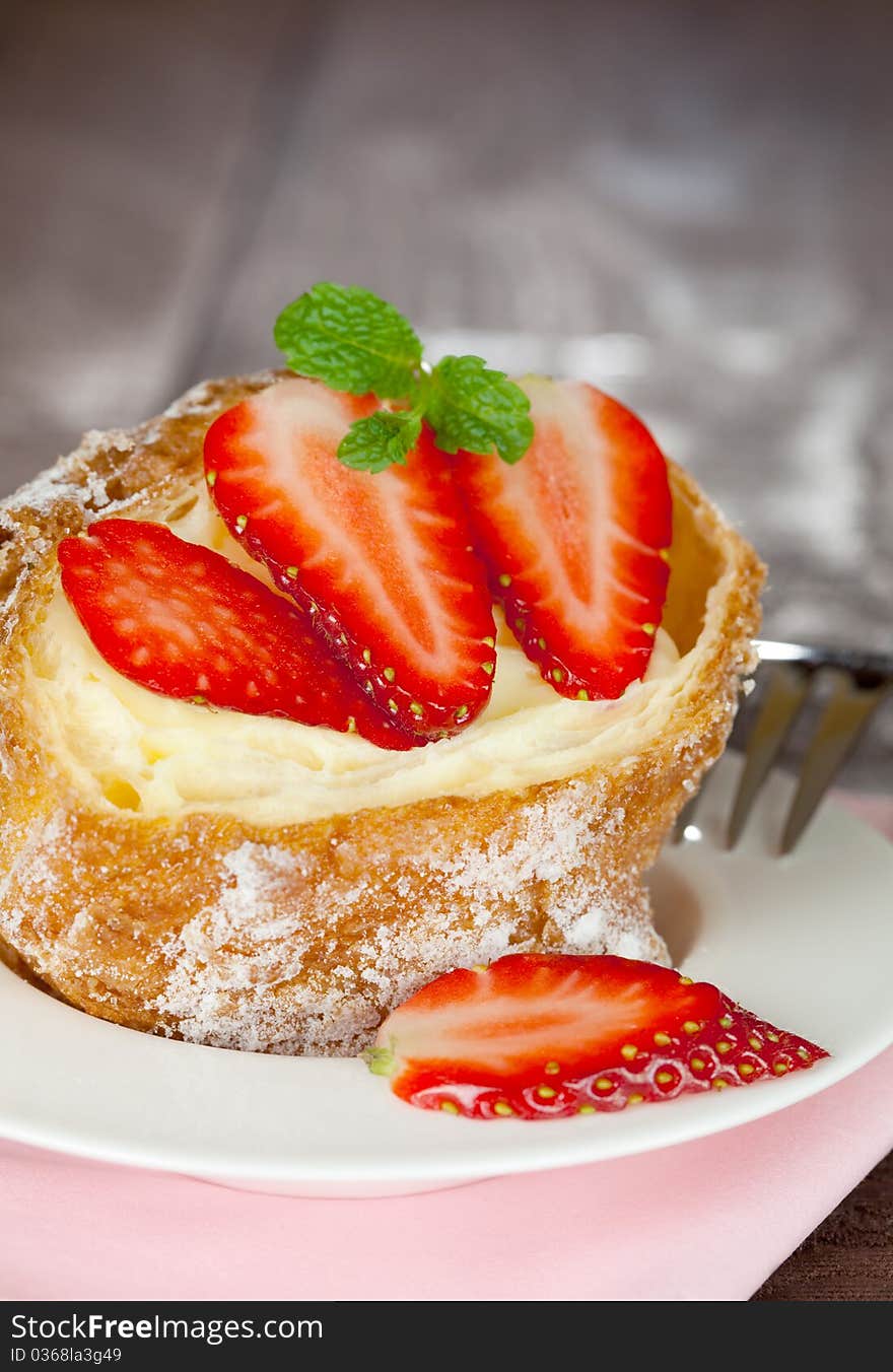 Fresh cream puff with strawberries selective focus. Fresh cream puff with strawberries selective focus