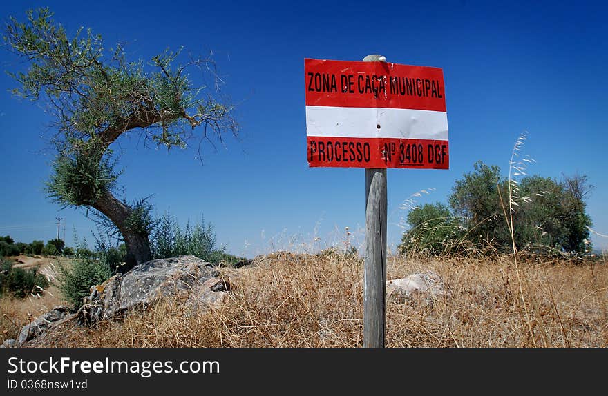 White an red sign under blus sky in burned fields by the sun. White an red sign under blus sky in burned fields by the sun