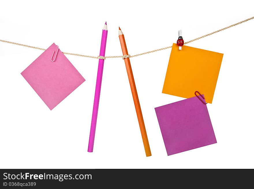 Note papers and colorful pencils on the rope isolated on white