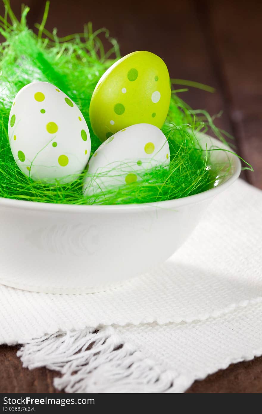 Three colorful eggs in a easter basket