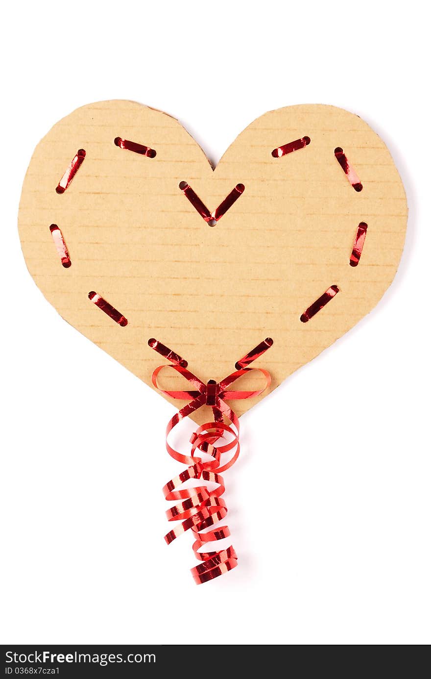 Cardboard heart with a red ribbon on white background