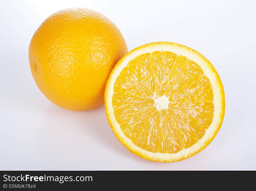 Ripe orange and half on white background. Ripe orange and half on white background