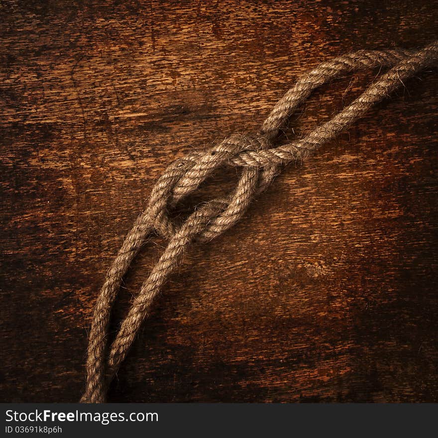 Rope on dirty wood background