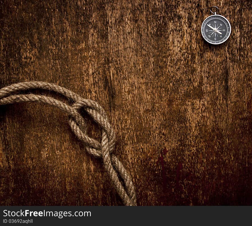 Compass and rope on grunge background