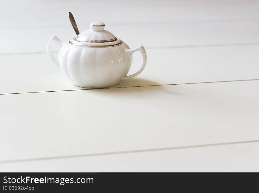 Vintage style Chinese porcelain sugar bowl on table in retro cafe. Vintage style Chinese porcelain sugar bowl on table in retro cafe.