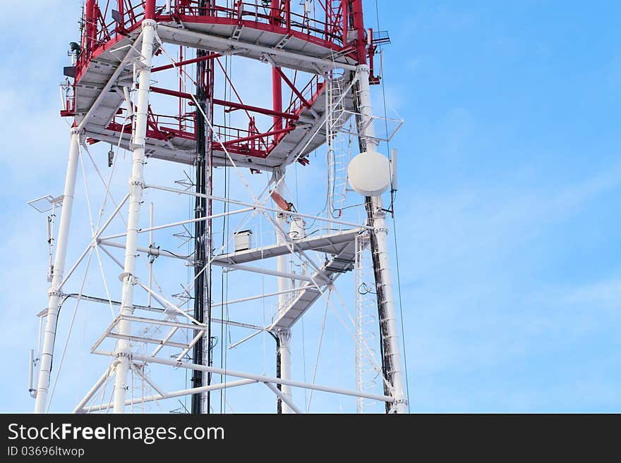 Telecommunication tower agains blue sky background