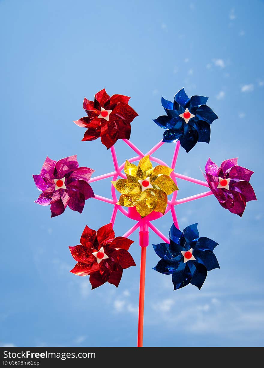 Colorful pinwheel agains clear blue sky