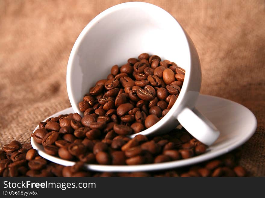 Cup, dish and beans of coffee. Cup, dish and beans of coffee