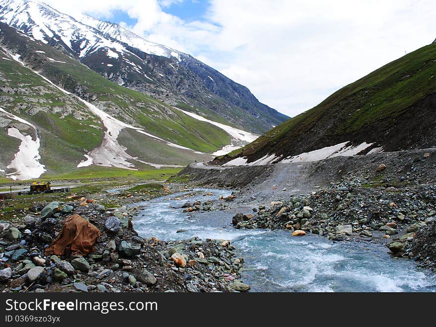 A beautiful scene with glaciers and snow peaks with a stream water flowing through. A beautiful scene with glaciers and snow peaks with a stream water flowing through.