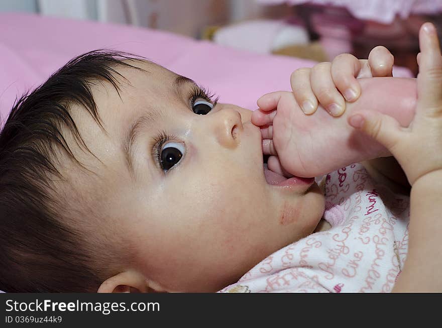 Baby Girl sucking her Toe