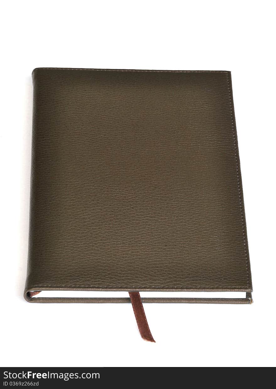 Dark brown leather notebook on white background.