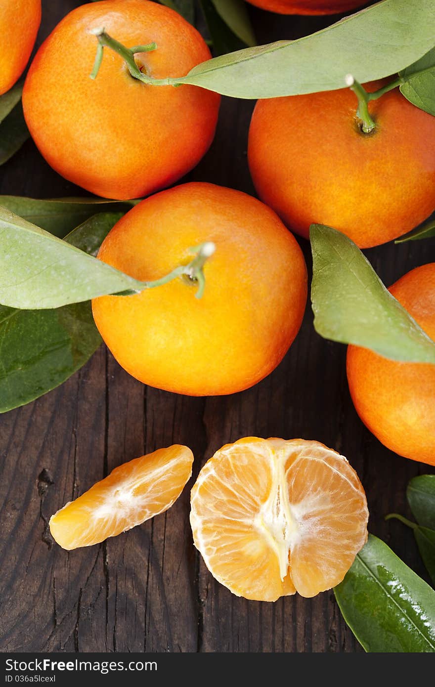 Ripe tangerines on a wooden table