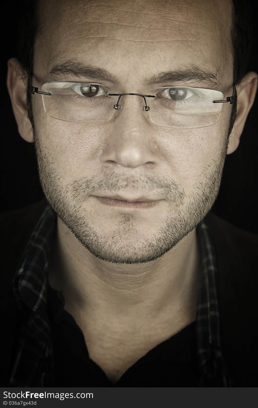 Portrait of a man, isolated over black background. Portrait of a man, isolated over black background