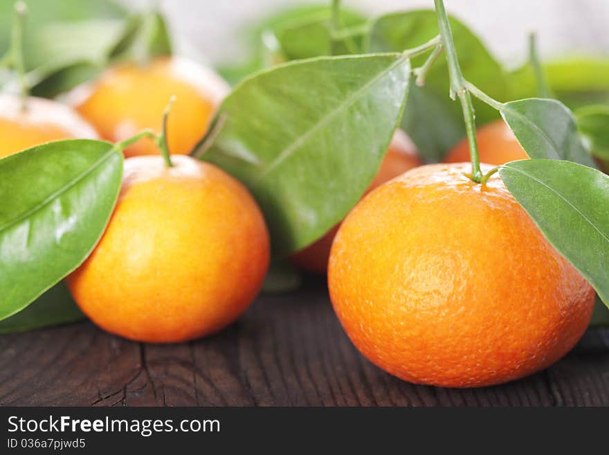 Ripe tangerines on a wooden table