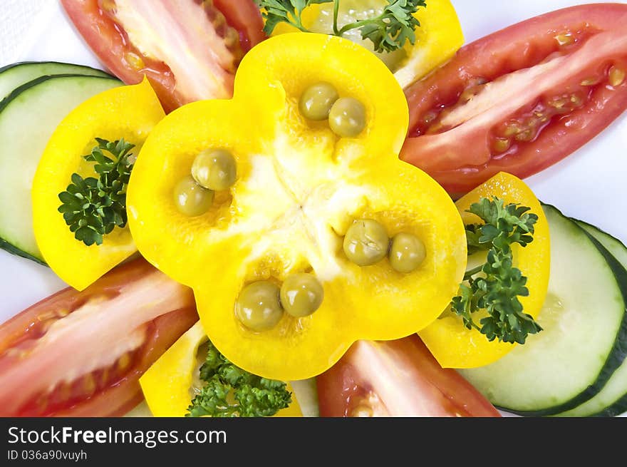 Colored raw vegetables for salad in plate on a table