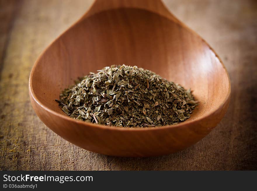 Oregano on wooden spoon