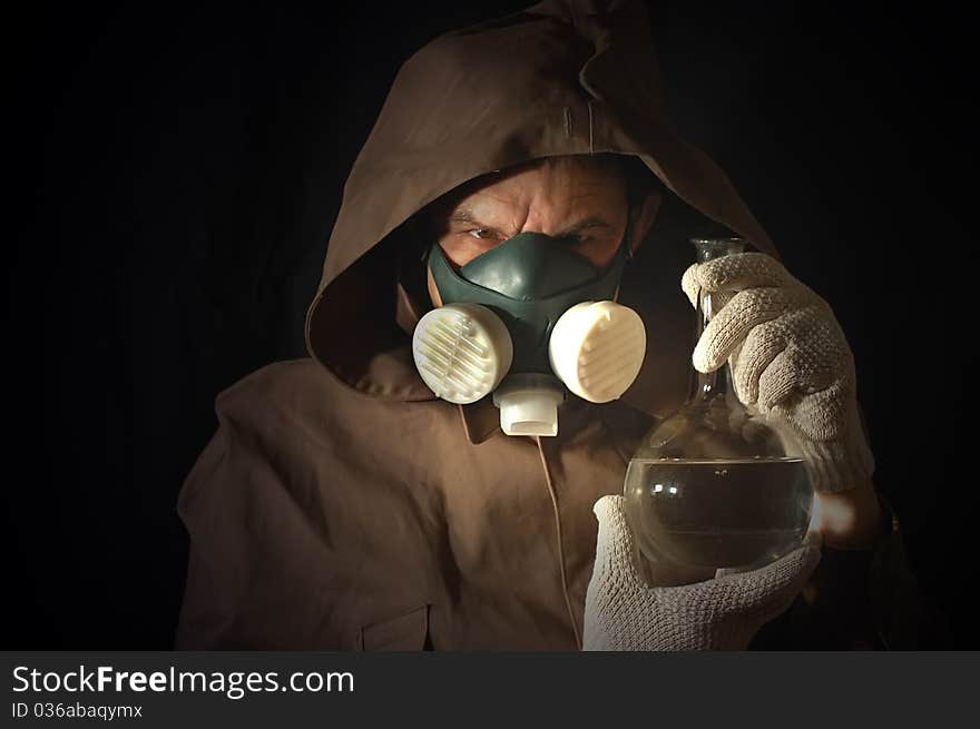 Man weared Soviet gas mask with lab flask. Man weared Soviet gas mask with lab flask