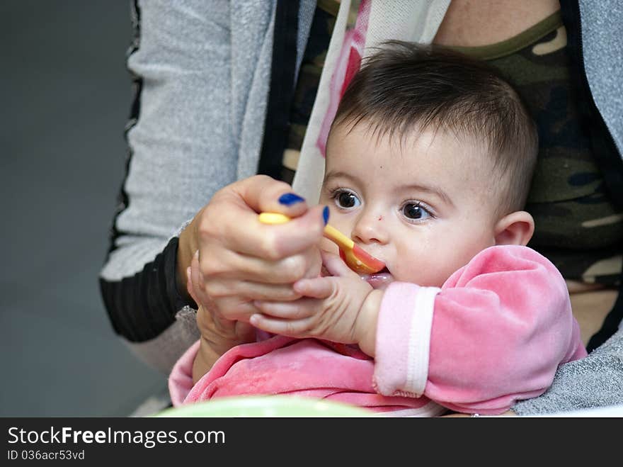 Baby Girl eating with her Mother, Italy