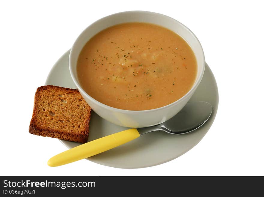 Vegetable soup with toast and spoon