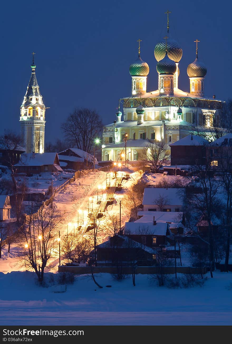 Illuminated church on high river coast