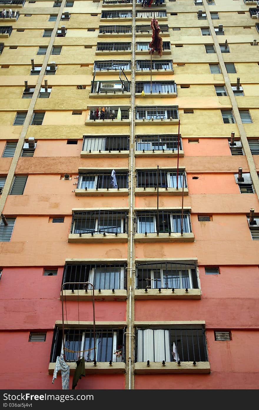 It is the public residential building in downtown of Hong Kong. It is in orange and yellow color. It is the public residential building in downtown of Hong Kong. It is in orange and yellow color.