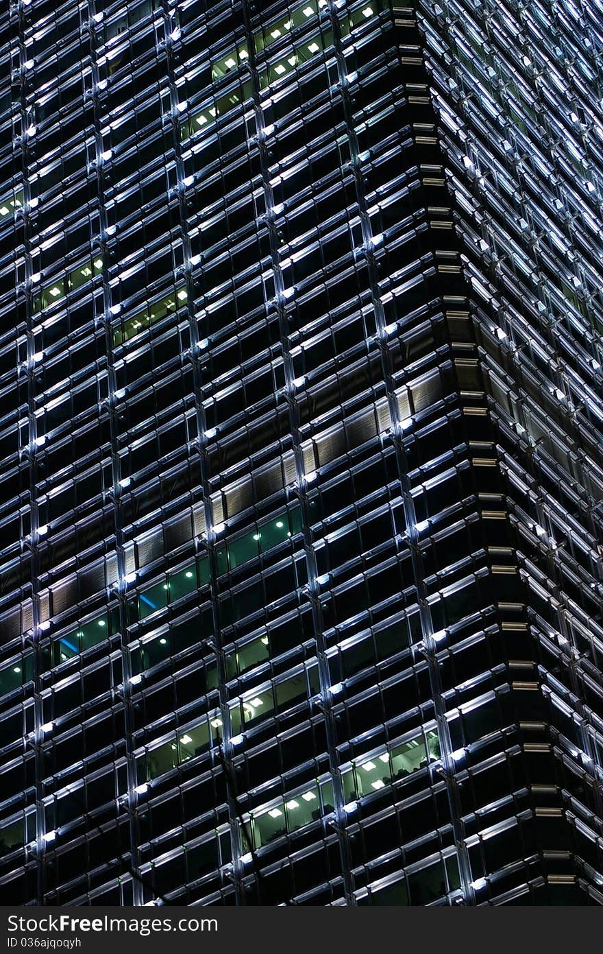 Window from a modern office and building in Hong Kong at night, can be used as background. Window from a modern office and building in Hong Kong at night, can be used as background