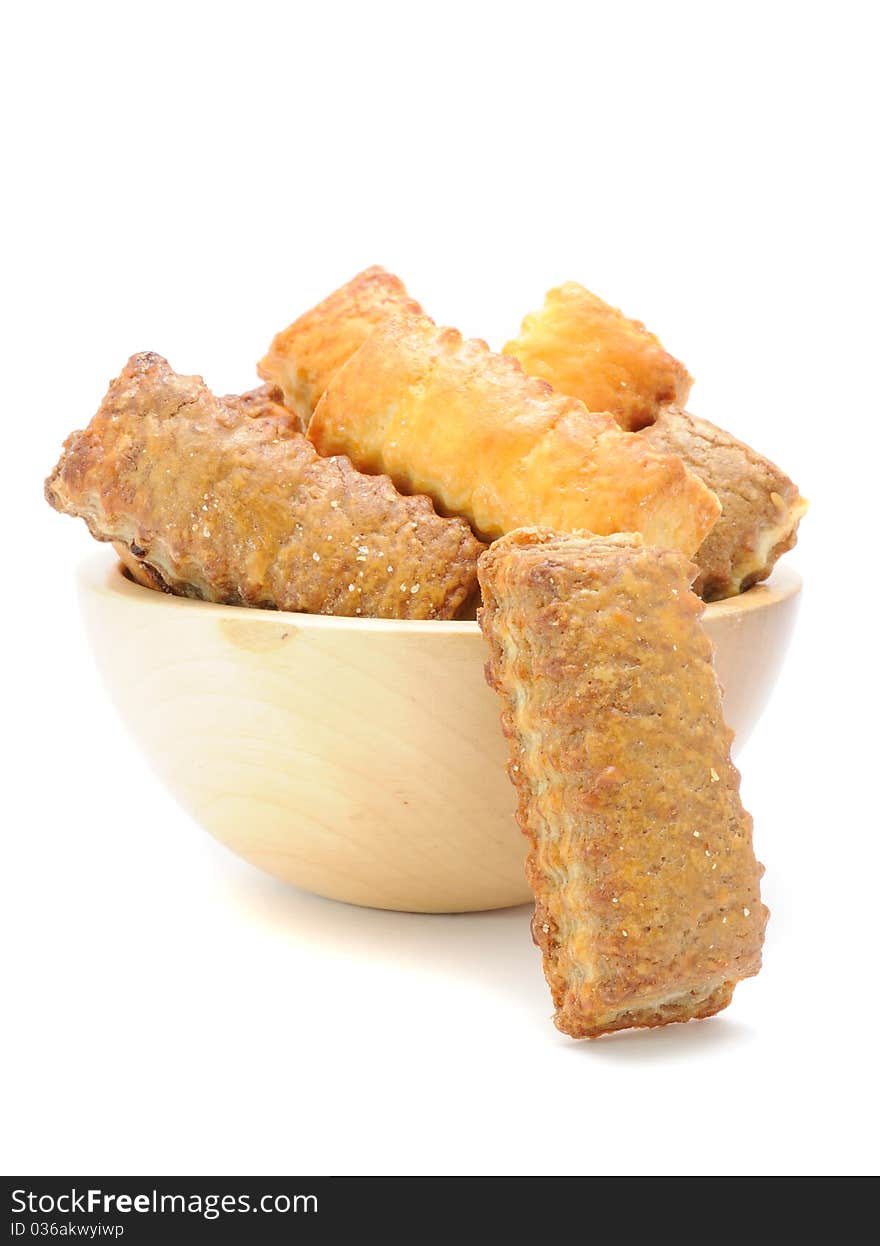 A bowl of flaky cookies isolated on a white background