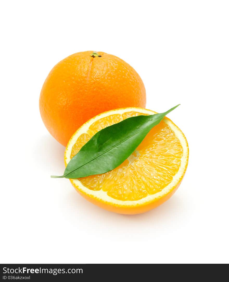 Juicy oranges with a green leaf isolated on a white background. Juicy oranges with a green leaf isolated on a white background