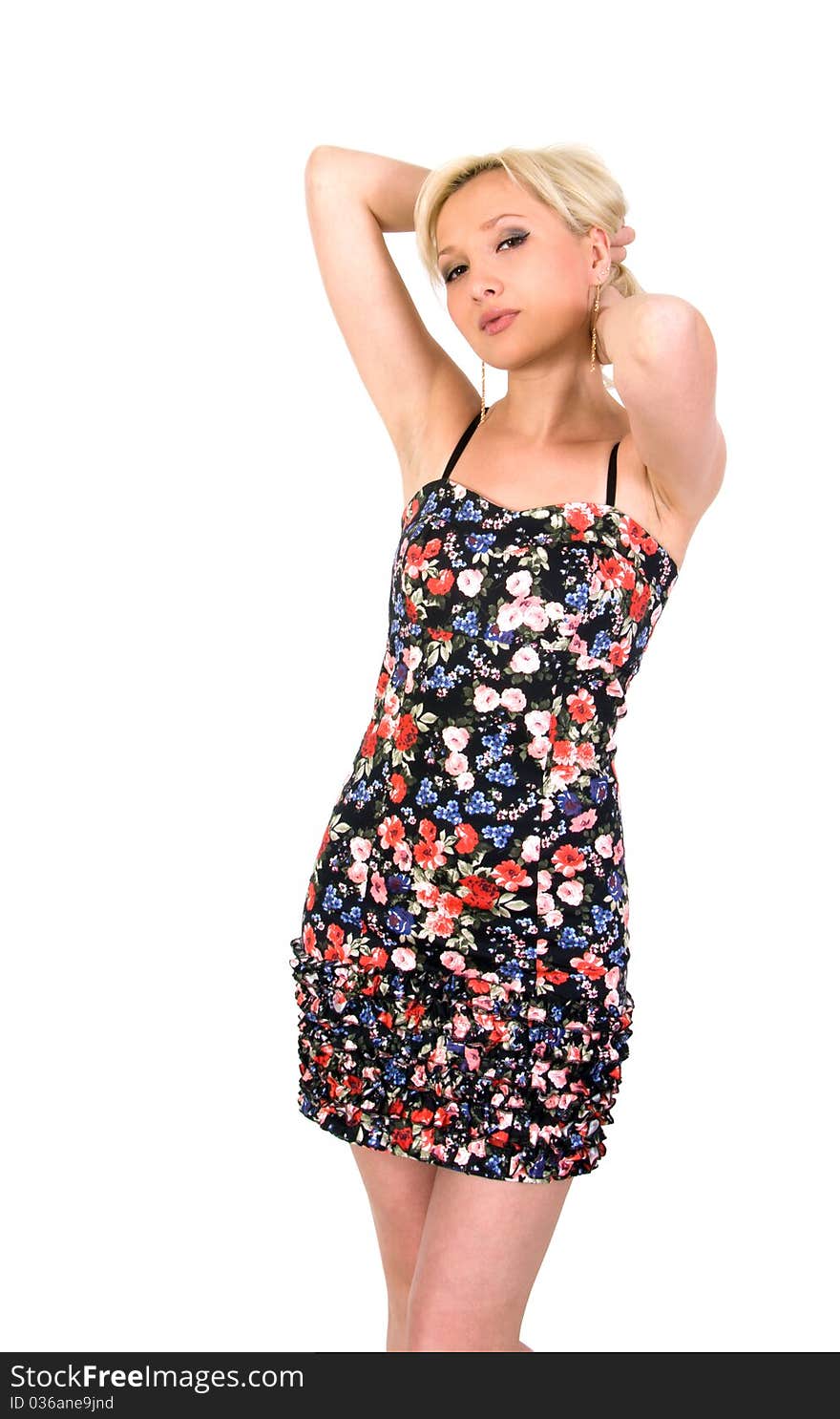 Girl in a flowery summer dress on a white background. Girl in a flowery summer dress on a white background.