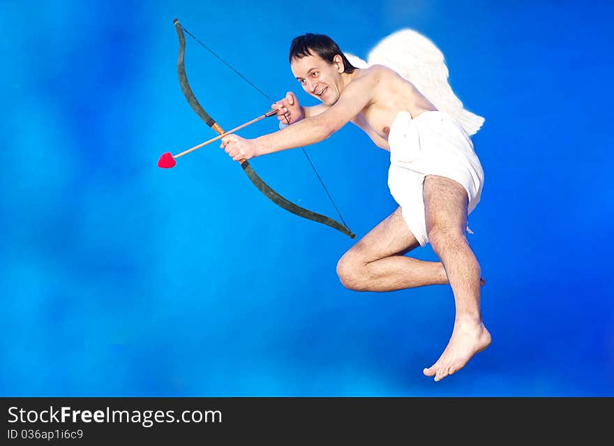 Cupid aiming with his hearth shaped arrow. Cupid aiming with his hearth shaped arrow