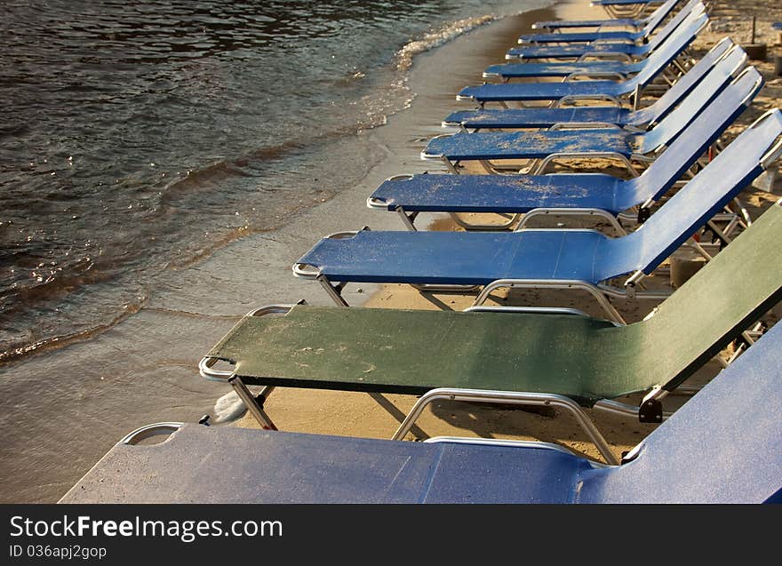 Row of beach chairs near seashore