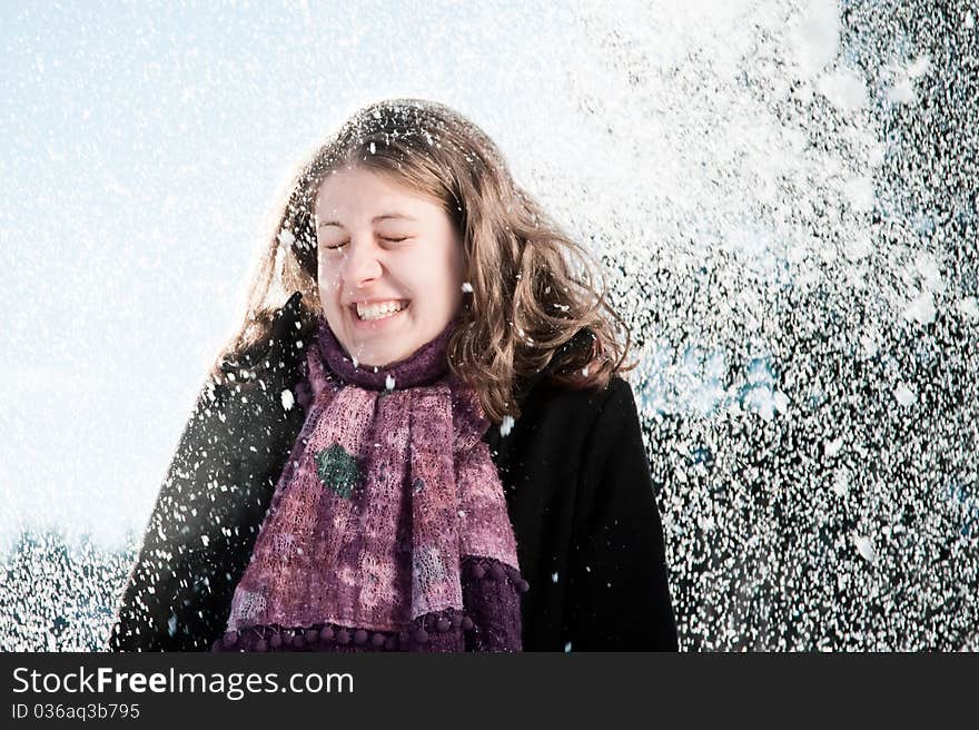 Happy young woman in  snowfall