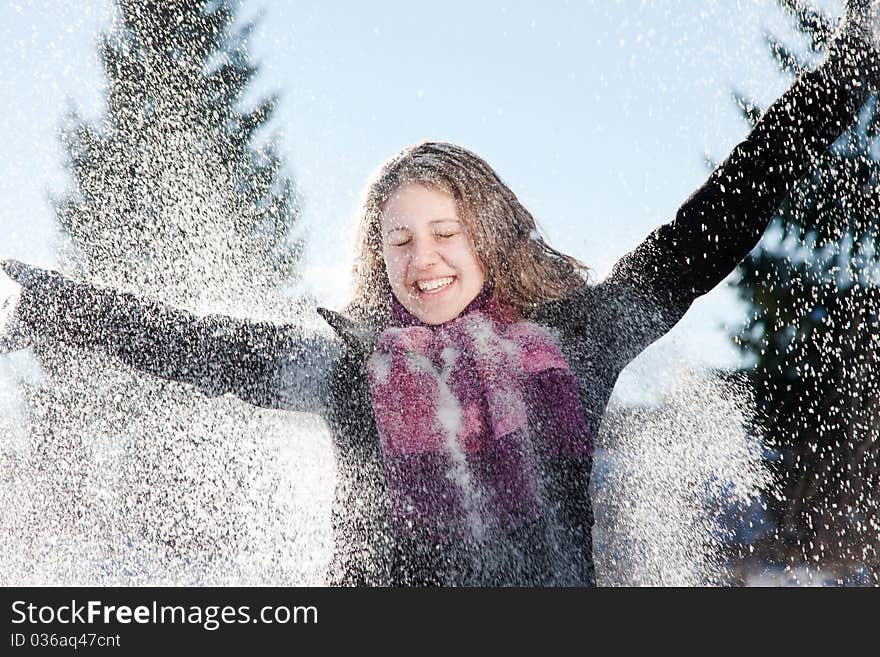 Happy young woman in heavy snowfall