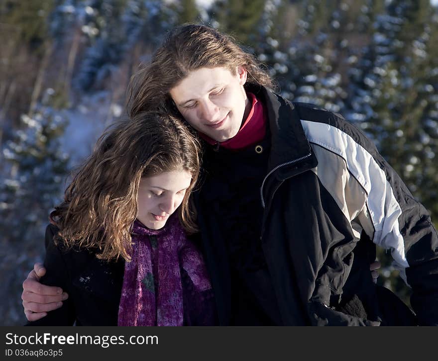 Happy young couple outdoors playing in snow