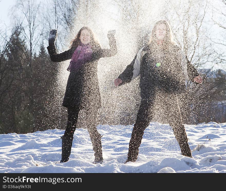 Happy young couple outdoors playing in snow