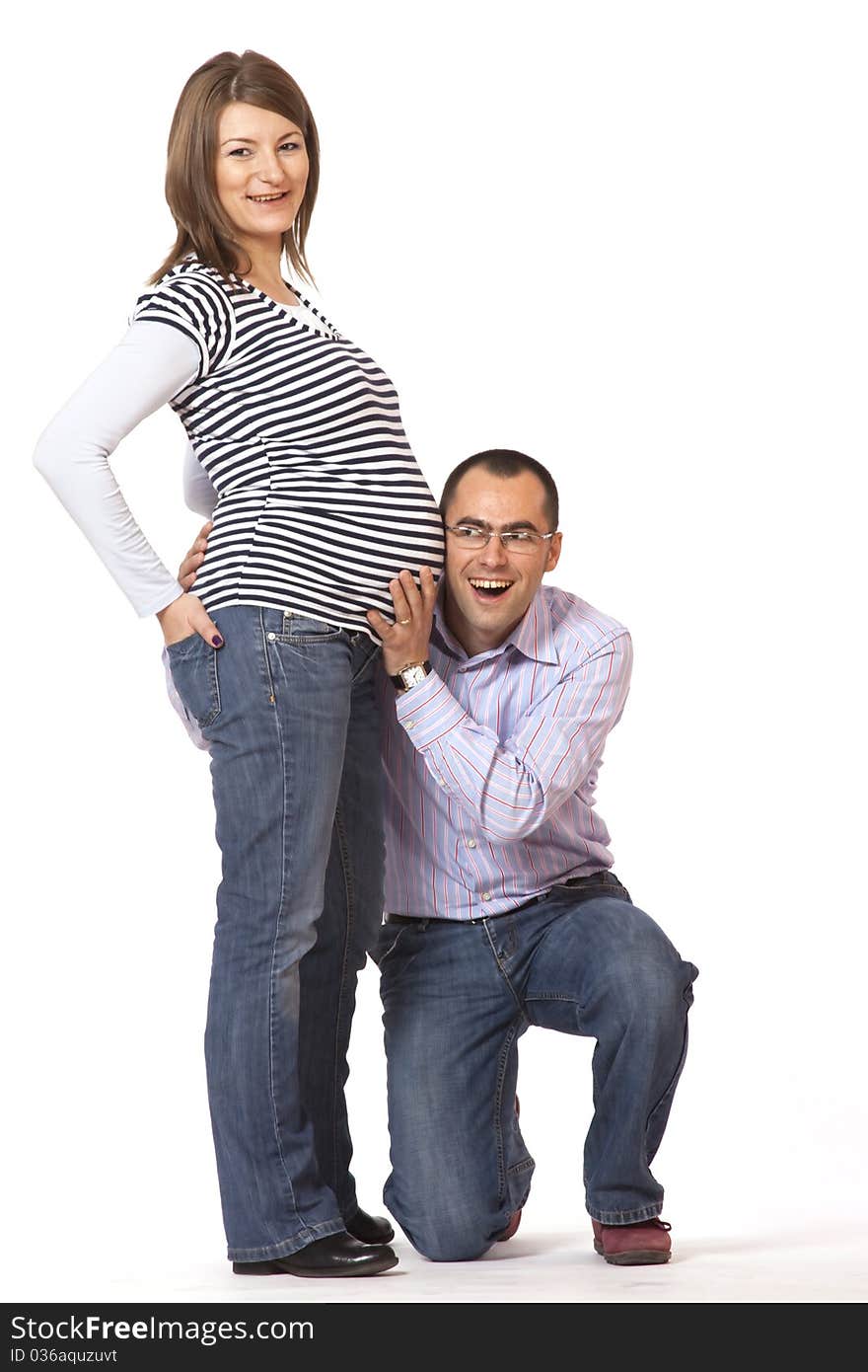 Happy young man and his pregnant wife isolated on white