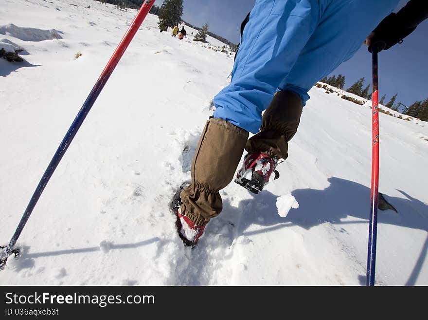 Hiker climbing in winter in mountains. Hiker climbing in winter in mountains