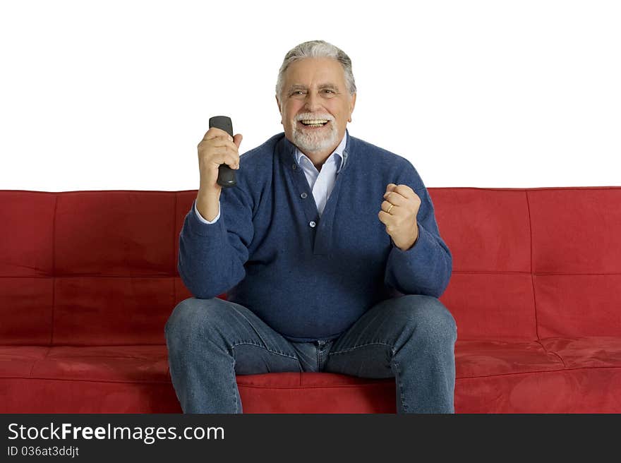 Old man on the sofa with television remote control