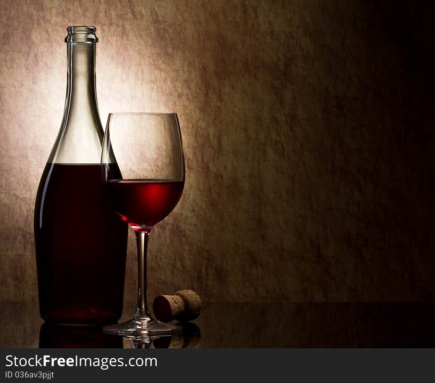 Bottle with red wine and glass and grapes