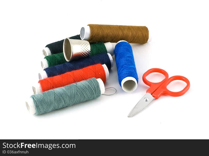 Colorful spools, scissors and a thimble