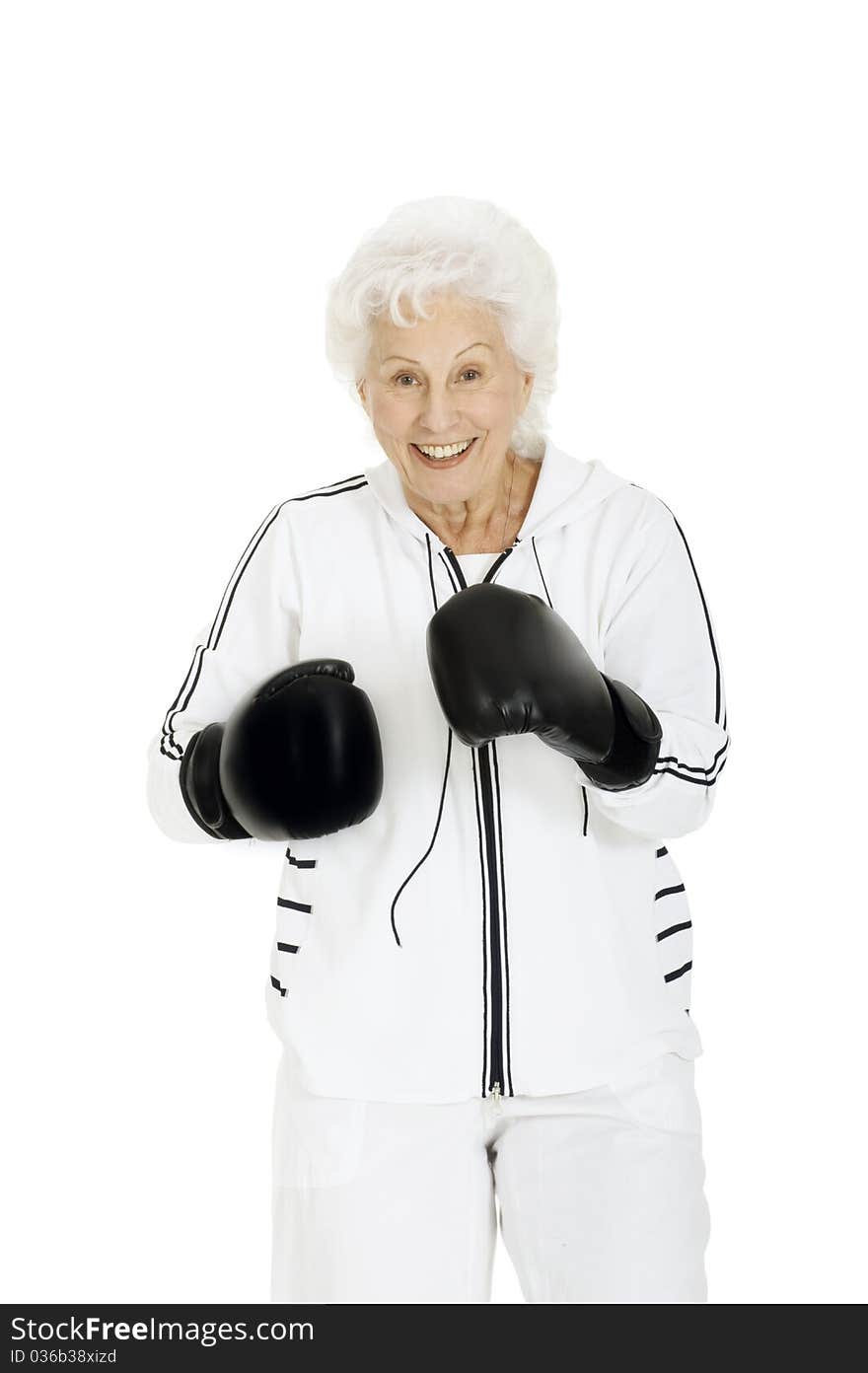 Elderly woman with boxing gloves in a white background