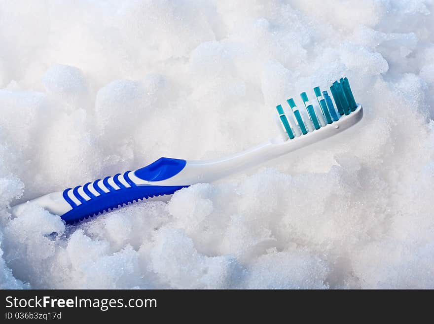 New blue toothbrush on a blue snow. New blue toothbrush on a blue snow