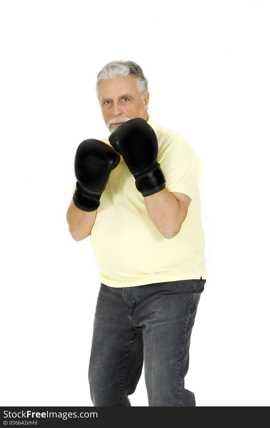 Elderly man with boxing gloves in a white background