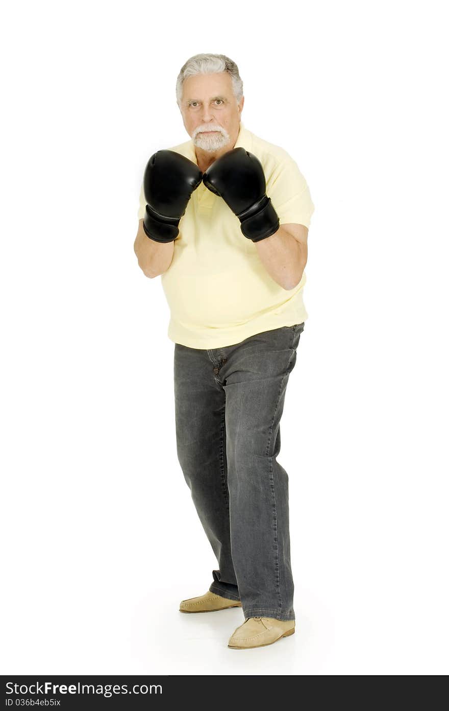 Elderly man with boxing gloves in a white background